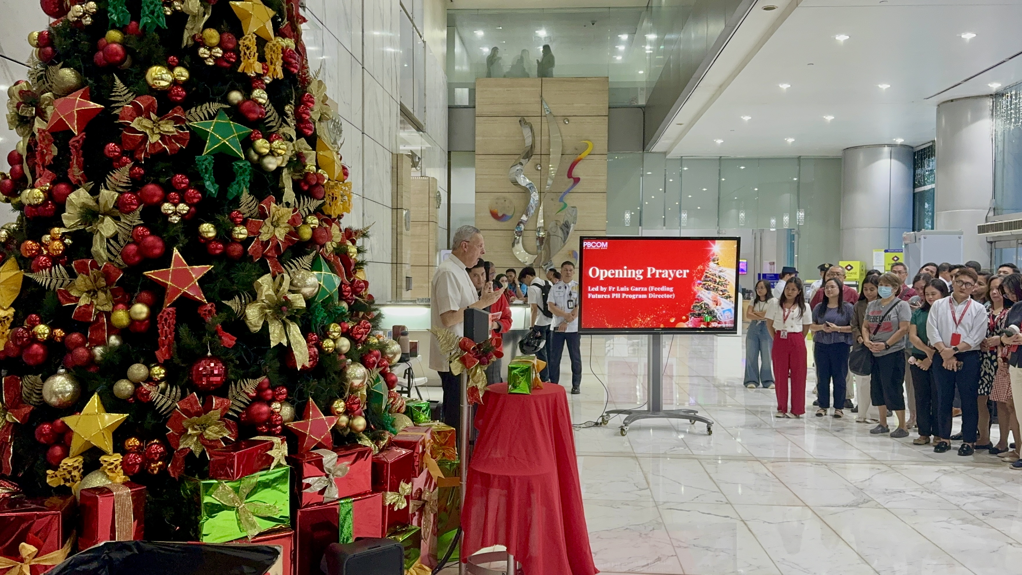 Fr. Luis Garza, LC leading the opening prayer at the PBCOM lobby.